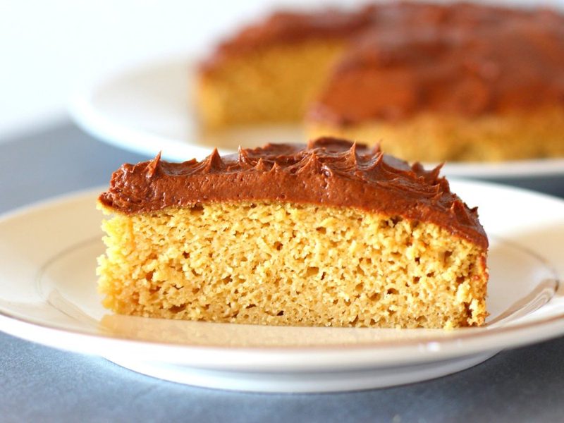 Slice of grain-free almond flour cake with chocolate frosting